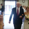 bride walks down the aisle with man her dad donated his heart to
