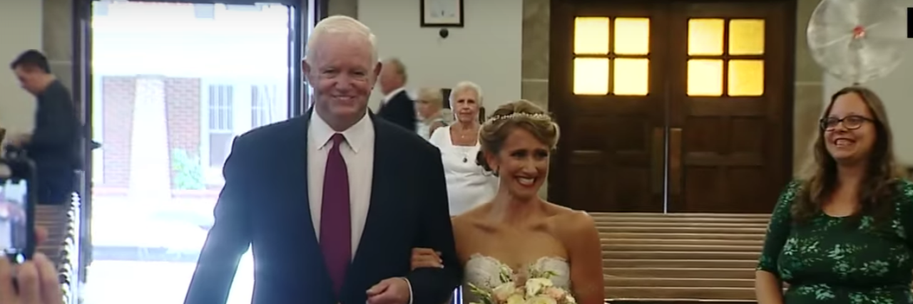 bride walking down aisle with man who got her father's donated heart