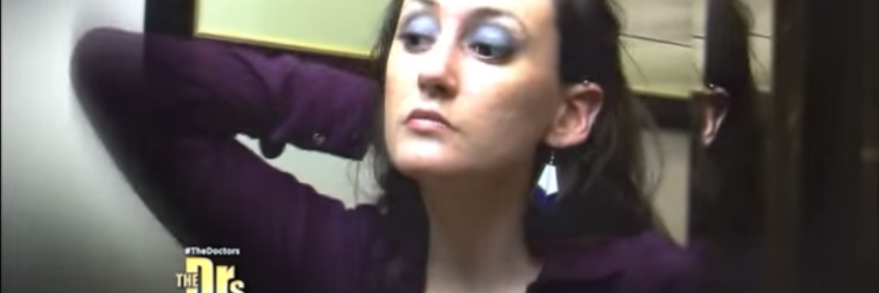 Appearing on 'The Doctors' Got Me Help for Dermatillomania a still of the author looking at her face on the show "The Doctors"