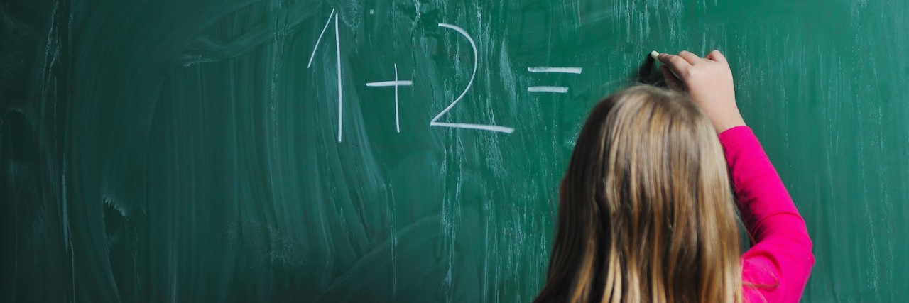 To the Student With Anxiety in Class female student answering a math question on a chalk board