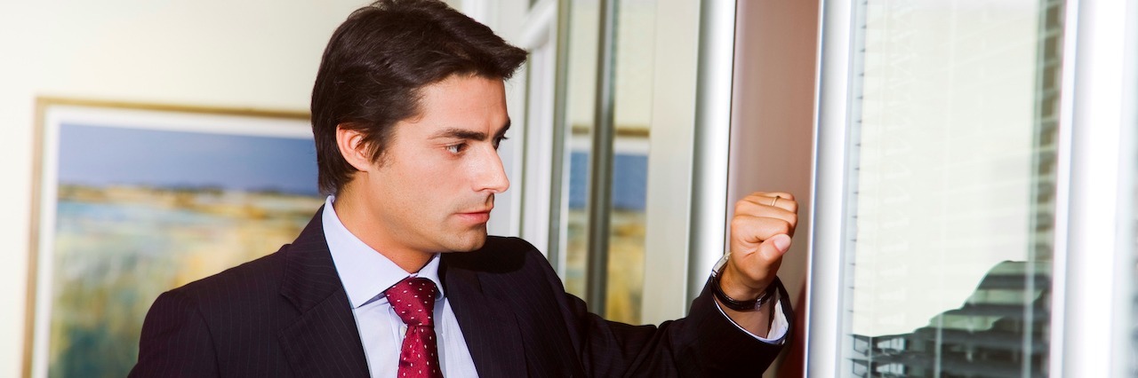 Talking to My Employer About My Generalized Anxiety Disorder A man in a suit in an office knocking on the door