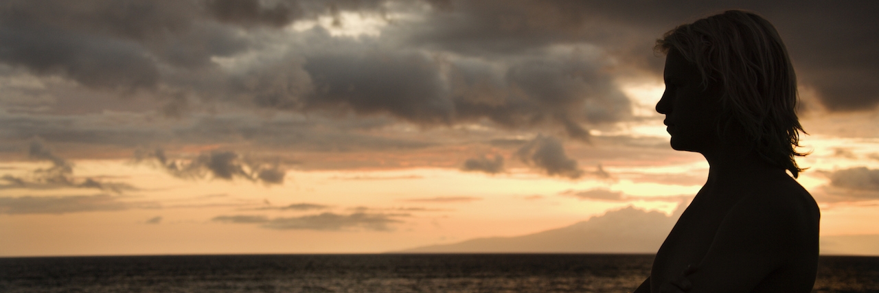 Suicide: To the Ones Who Want to Give Up a woman standing in front of a sunset