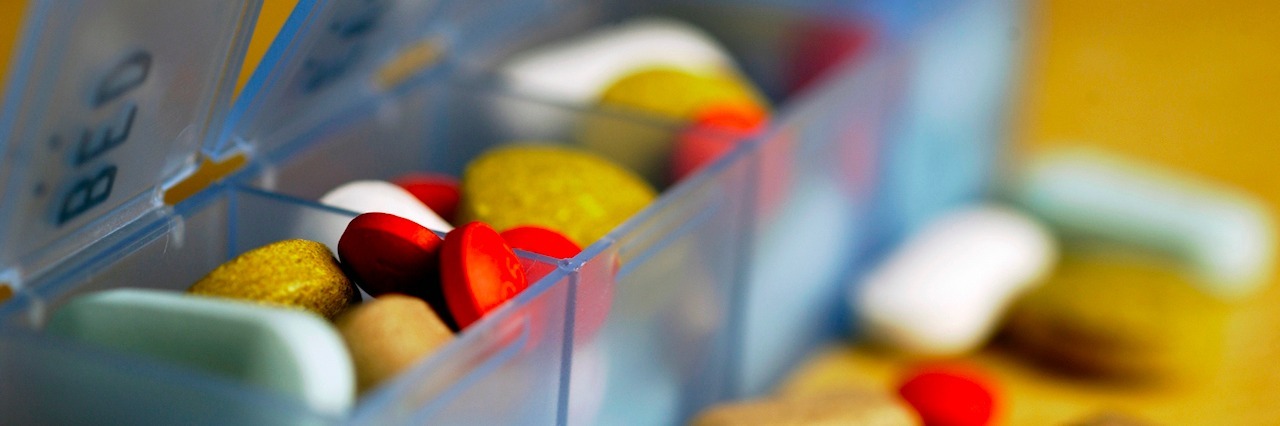 Opioid Epidemic and Medical Marijuana: Letter to My Congressman pill organizer filled with multicolored pills