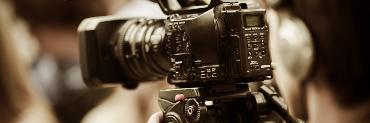Changing the Portrayal of Neurofibromatosis in the Media professional camcorder on the tripod, selective focus on nearest part