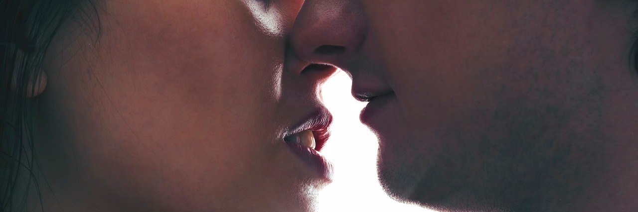 Hypersexuality: The Part of Bipolar Disorder No One Talks About A couple kissing with the sun bright behind