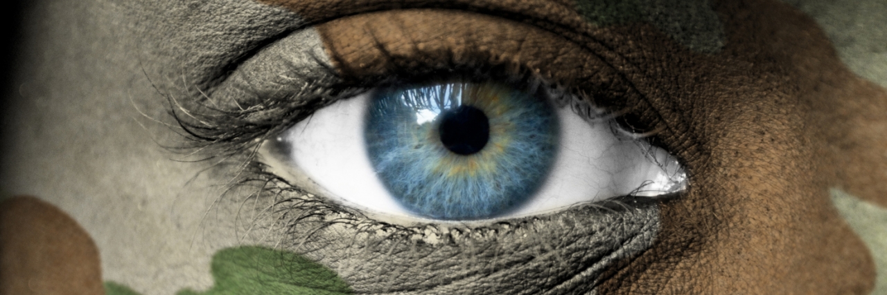 woman's eye with camoflouge around it