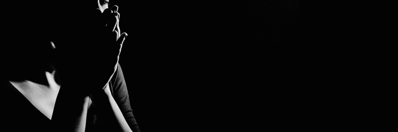 Why It's OK to Be Sad About Your Illness Young woman in the dark crying,she is feeling hopeless