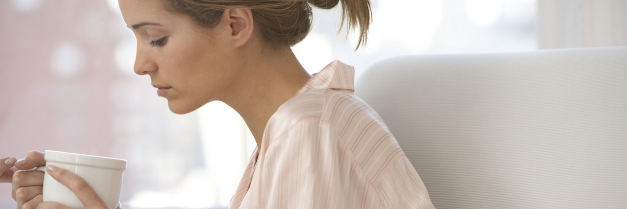 How to Get Yourself Out of the House When Dealing With Depression Young woman on sofa