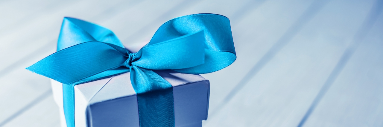 How Stuttering Has Been an Unexpected Gift Gift box on wood table.