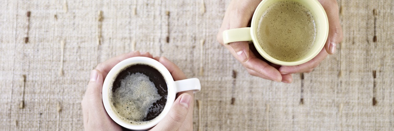 Reasons Why You Shouldn't Hide Your Chronic Illness two people talking while drinking coffee.