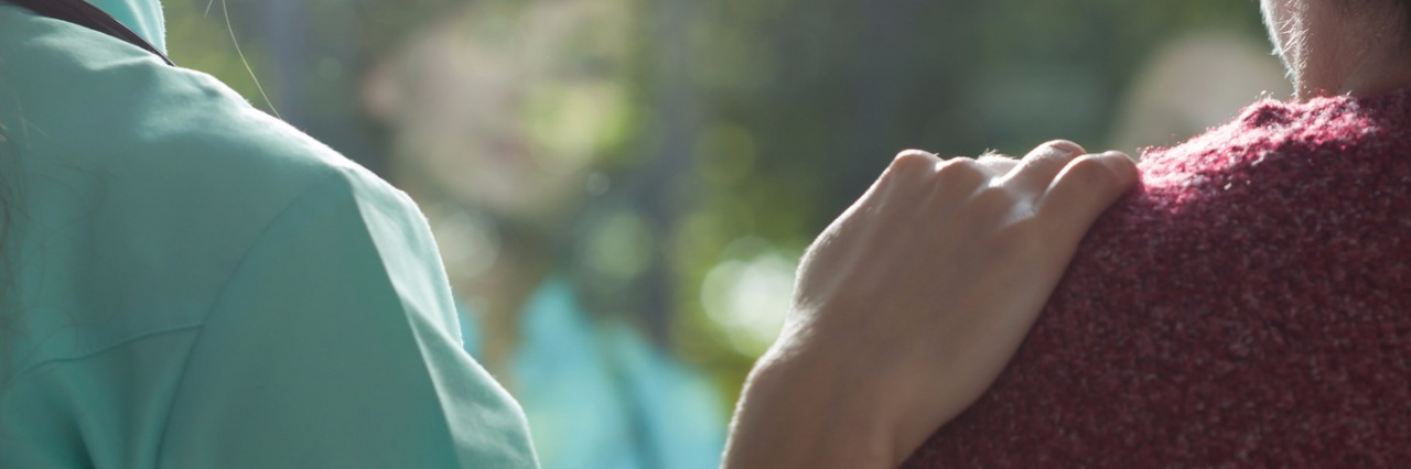 How to Help When Someone's Partner Is in a Psychiatric Hospital Woman putting hand on another woman's shoulder