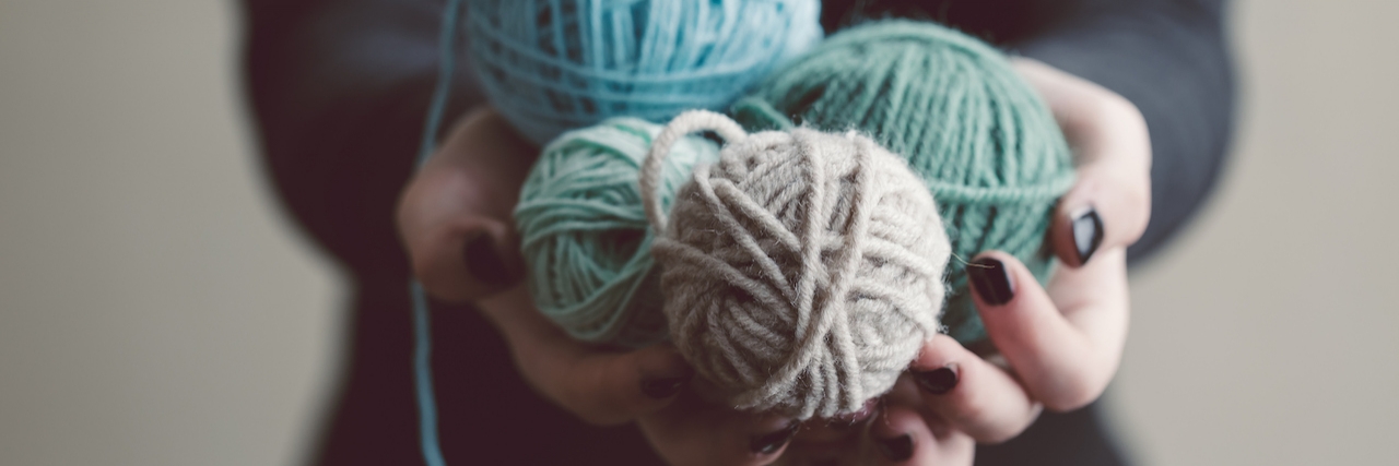 Frustration of Dealing With Lupus and Autoimmune Disease Hands holding balls of yarn