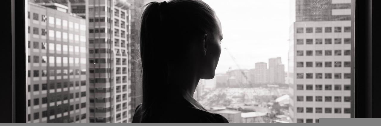 How Bipolar Disorder Affects My Work Woman look out of office window thinking.
