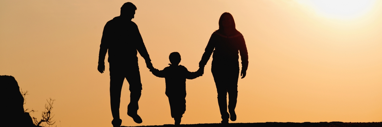 Learning to Choose Hope as the Parent of a Child With Dravet Syndrome silhouette of family on the outdoor at dusk.