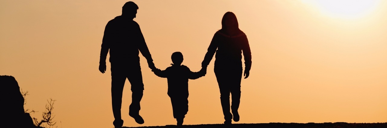 A Letter to the Parents of Children With Duchenne Muscular Dystrophy silhouette of family on the outdoor at dusk.