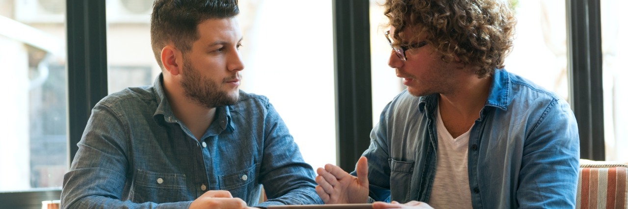 2 Ways You Can Help People With Mental Illnesses two young men chatting in a cafe