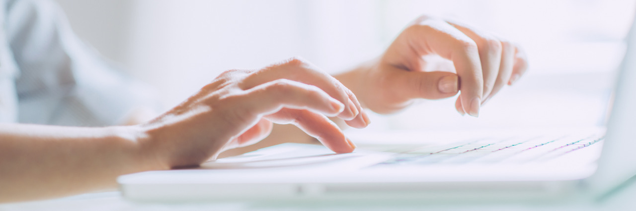 Supporting People When Disability Becomes Part of Their Lives Woman working on laptop.