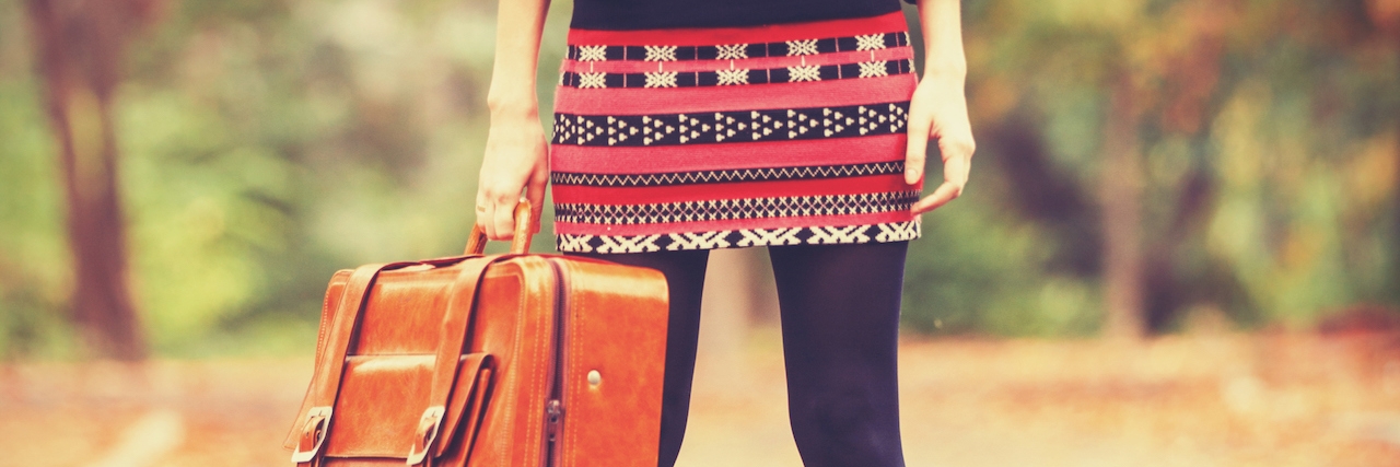 My Journey With Depression From Diagnosis to Advocacy girl holding a suitcase