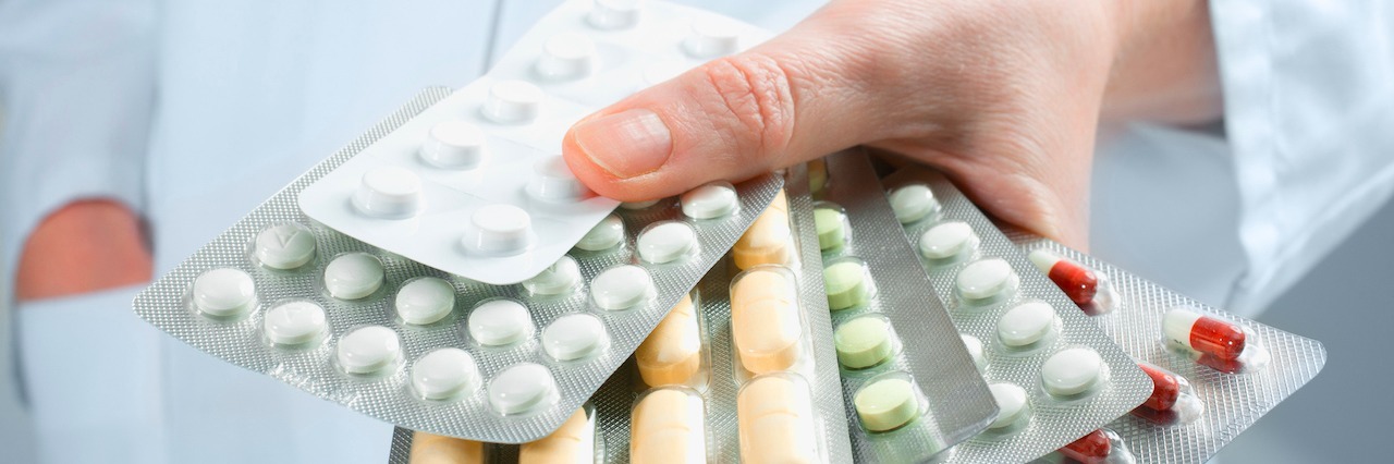 What It Feels Like When Your Medications Don't Work Hand of doctors holding many different pills