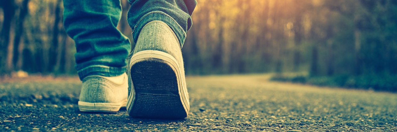 What Someone Just Diagnosed With Major Depressive Disorder Should Know close up on feet walking down a road