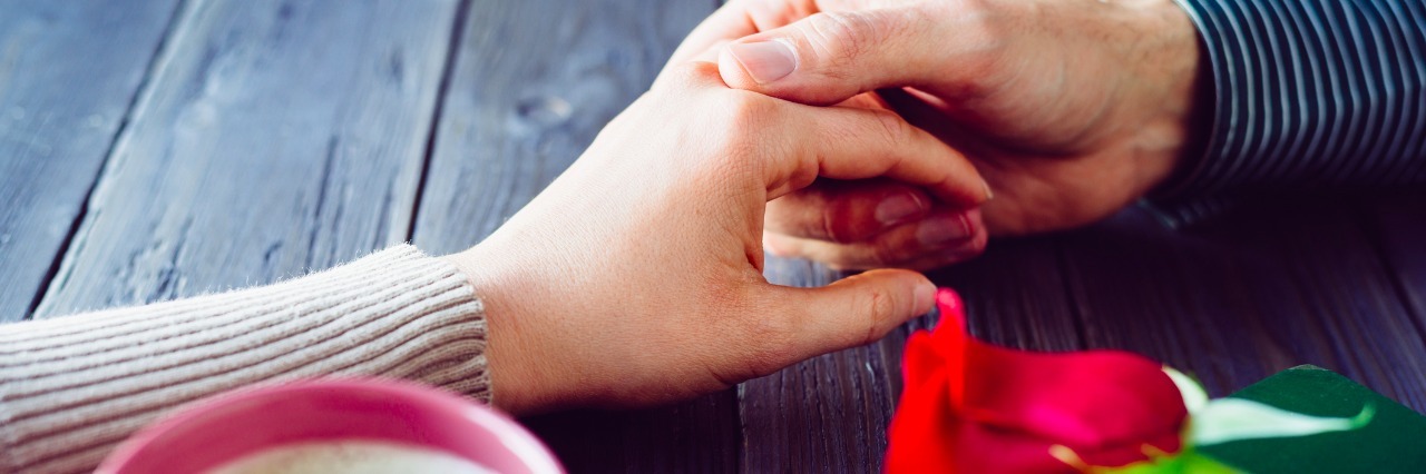 The Challenges of Dating With Erythromelalgia Romantic lovers dating. Male and female hands caressing with love. Couple on secret dating at coffee shop.