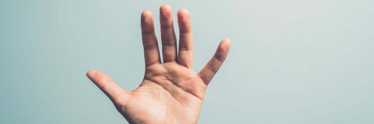 Why We Shoudn't Ignore the First Signs of Self-Harm a hand reaching up
