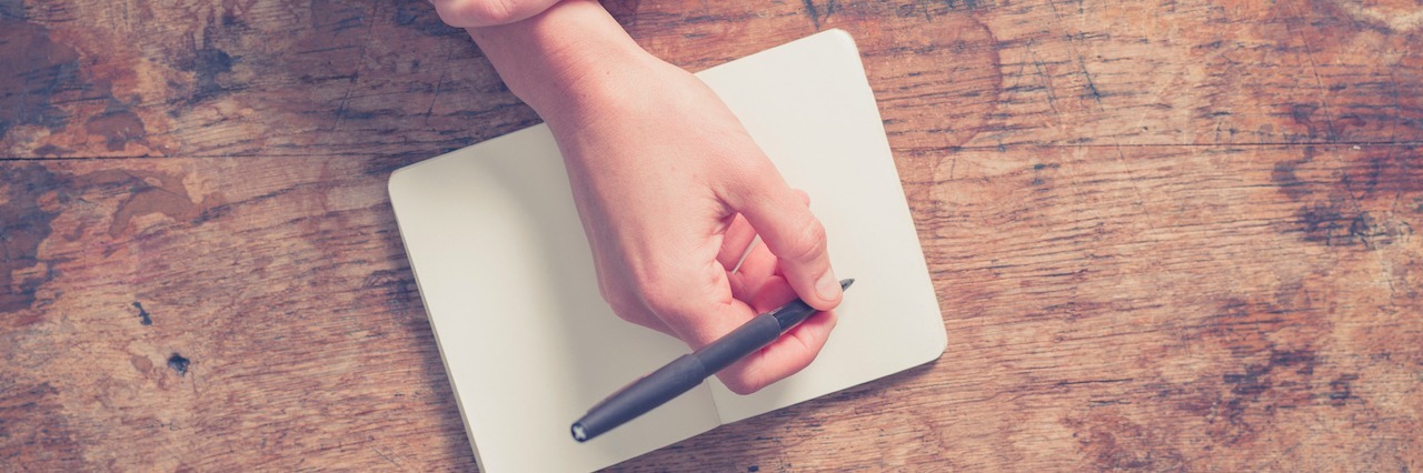 Journal Entries Documenting Anorexia Recovery woman writing in a notebook