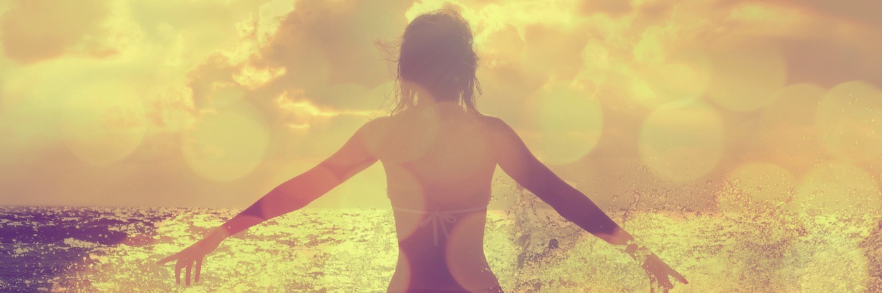 Why It's OK That I Have a Mental Illness woman looking at the ocean with her hands out