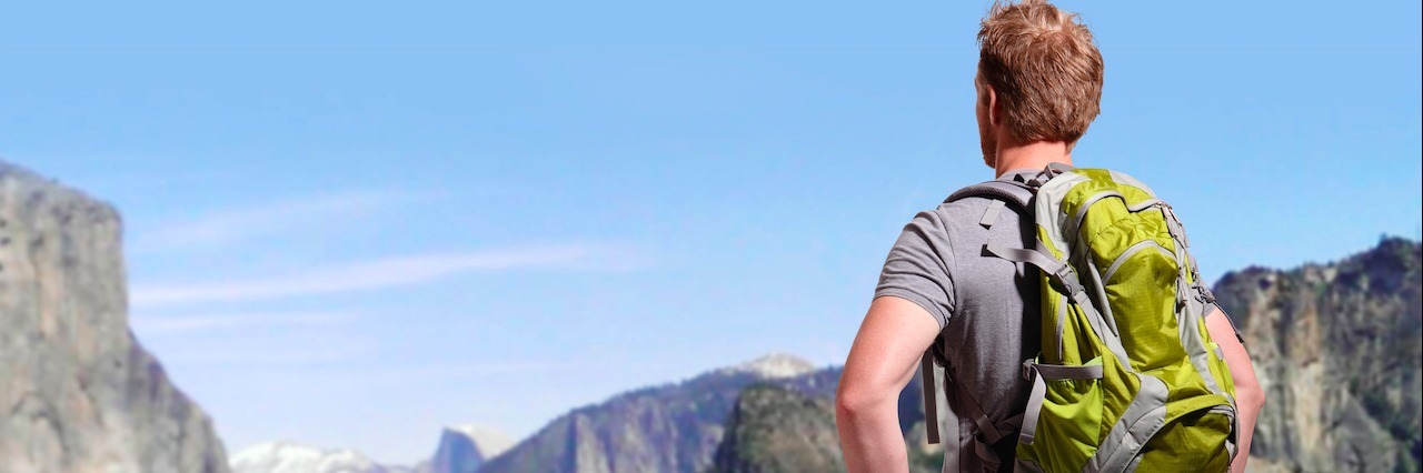How I Deal With Not Being Able to Hike Because of Osteoarthritis man with backpack standing at Yosemite