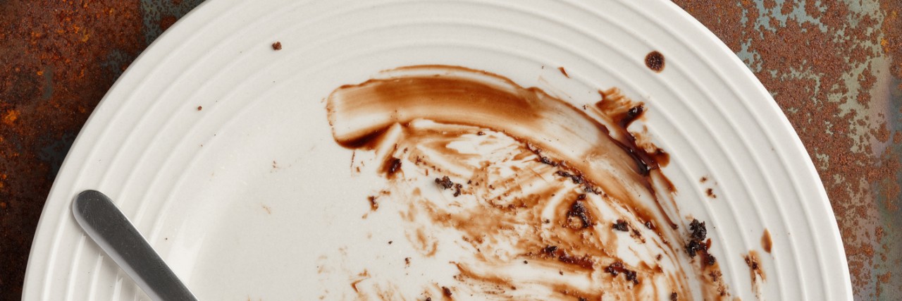 Dirty dessert plate on a grunge rustic background