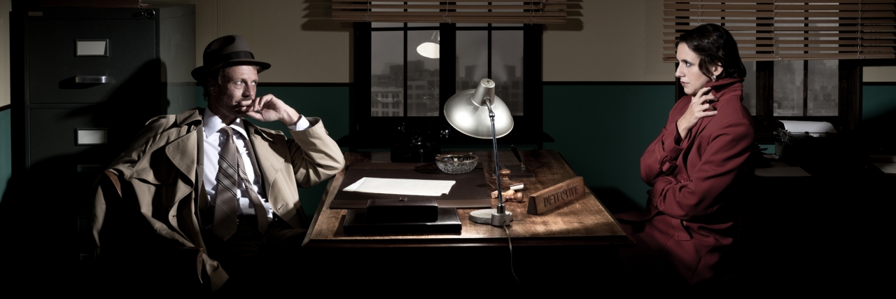 When Should You Tell a Date or Employer You Have a Disability? detective at office desk interviewing a young woman, 1950s film noir style.