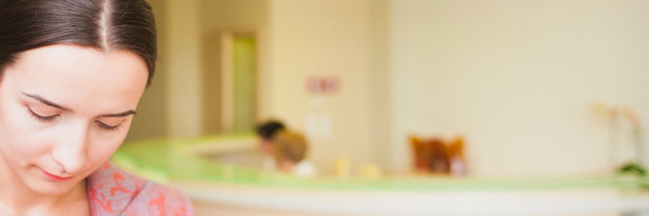 When I Discharged From My Eating Disorder Unit Woman woman leaving clinic with sad look on face