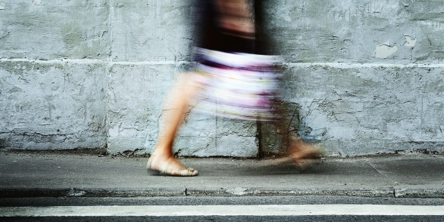 a woman walking on the sidewalk