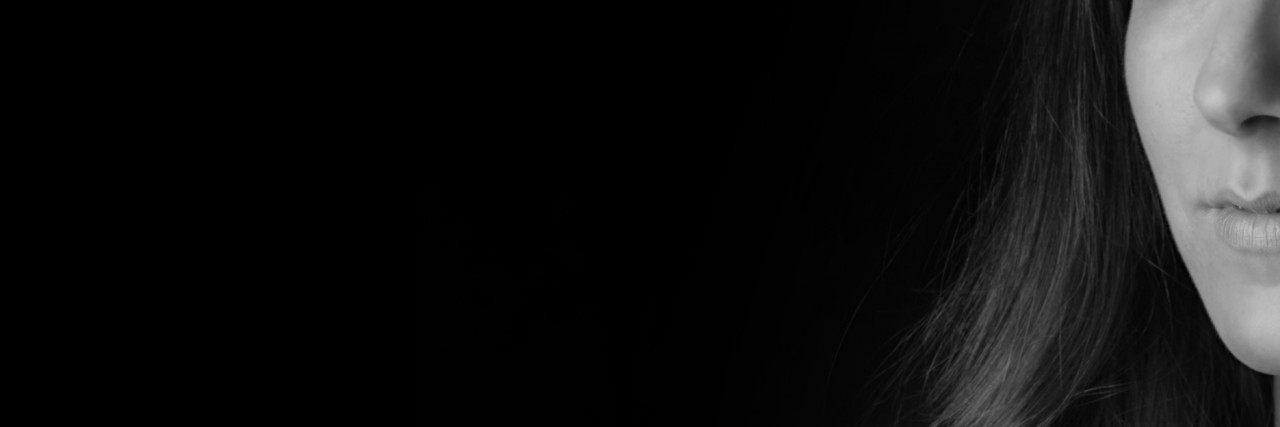 'I'm Not OK': How Do You Know When You're OK? A black and white half portrait of a young women looking straight in the camera.