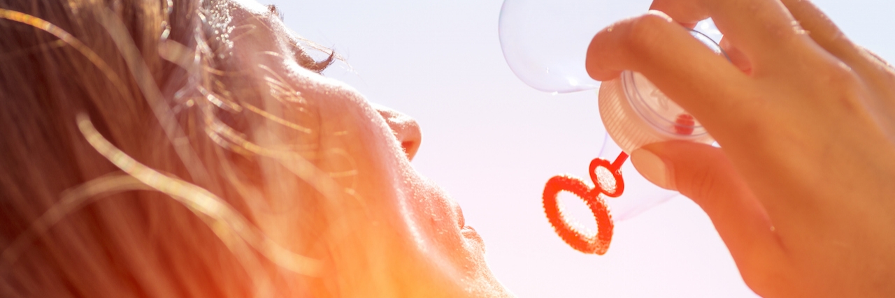 a woman blowing bubbles