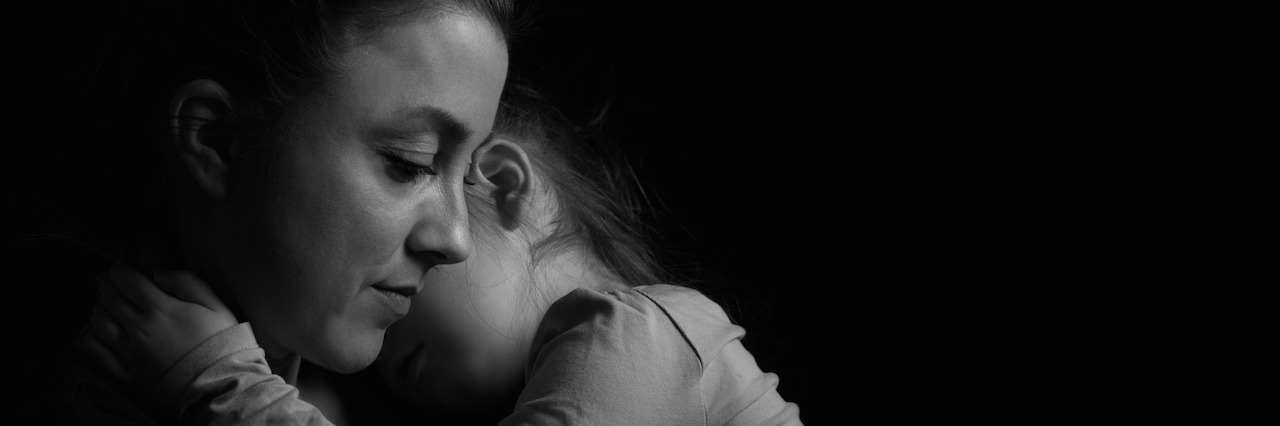 What It's Like Living With Postpartum Depression mother holding her child