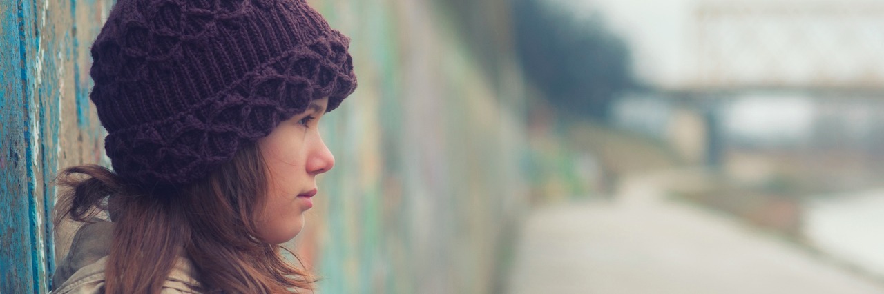 What It Feels Like When People Doubt Your Disability Portrait of lonely teenage girl on moody winter day.