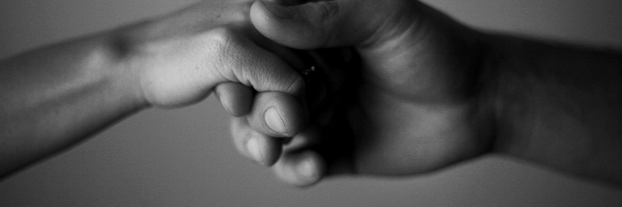 Letter to People Who Stay With Me During Anxiety and Depression Stock photo of a male and female holding hands.