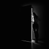 a woman i darkness opening a door
