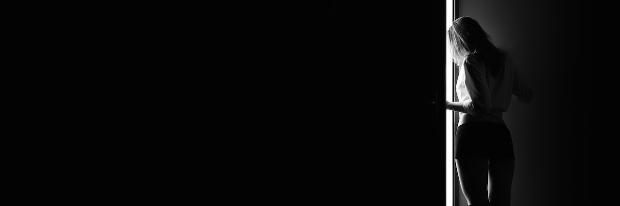What It's Like to Have Agoraphobia When You Can Leave Your House a woman i darkness opening a door
