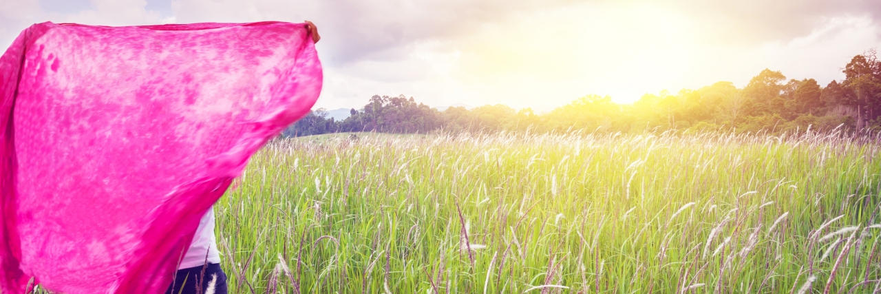 Experiencing Difficulty in School as a Teenager With Hypotonia Woman with natural prairie sky, Khao Yai National Park.