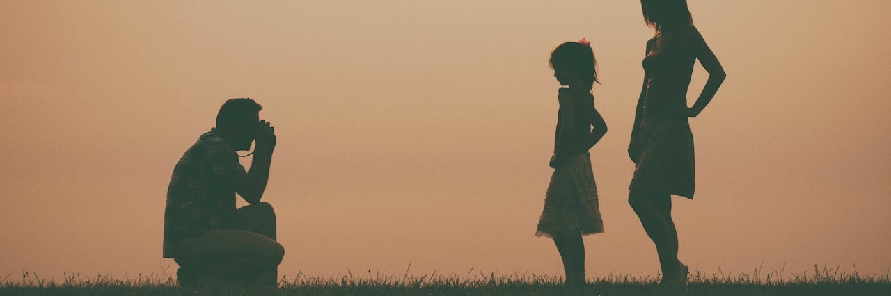 Silhouette of a man photographing his family