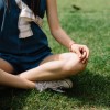 Close up of Girl sitting on grass with crossed legs