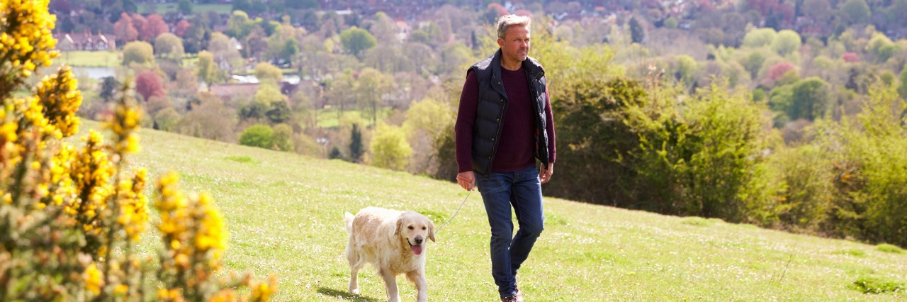Ways Depression Can Make You a Better Person Mature Man Taking Golden Retriever For Walk In Countryside