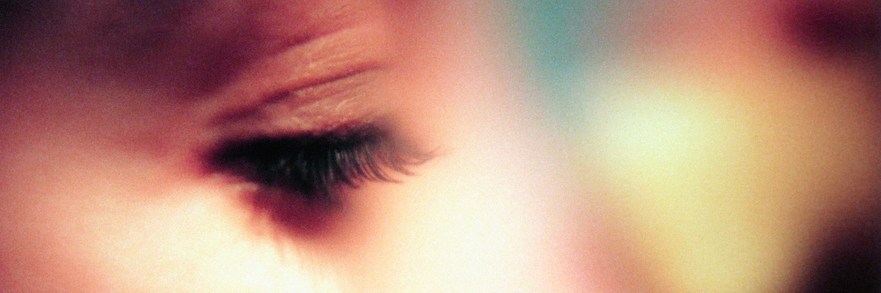 What to Know About the Lifelong Battle Against Bipolar Disorder close up on the woman's eyelashes