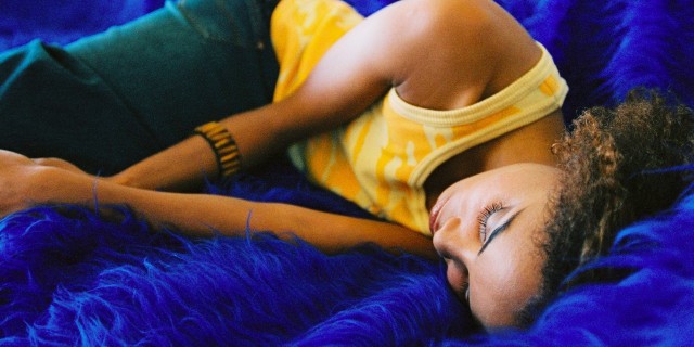 The One Thing I Will Stop Saying To Myself With Chronic Illness a young woman sleeping on a couch