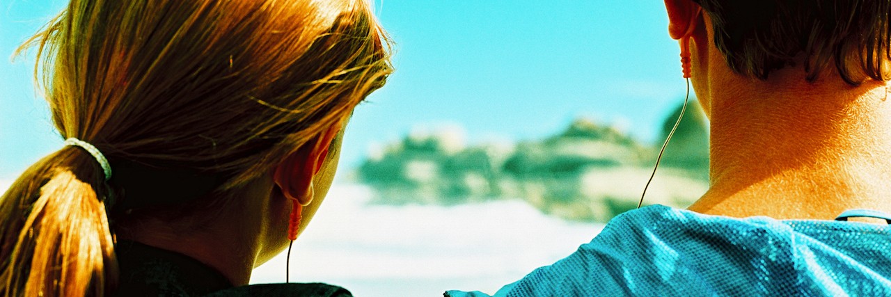 To the Friend Who Found My Knife I Used for Self-Harm rear view of a teenage couple sharing a pair of ear phones