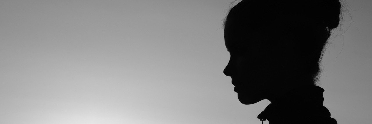 What Life With Chronic Pain Is Like Silhouette of the girl in the nature at summer sunset in black and white.