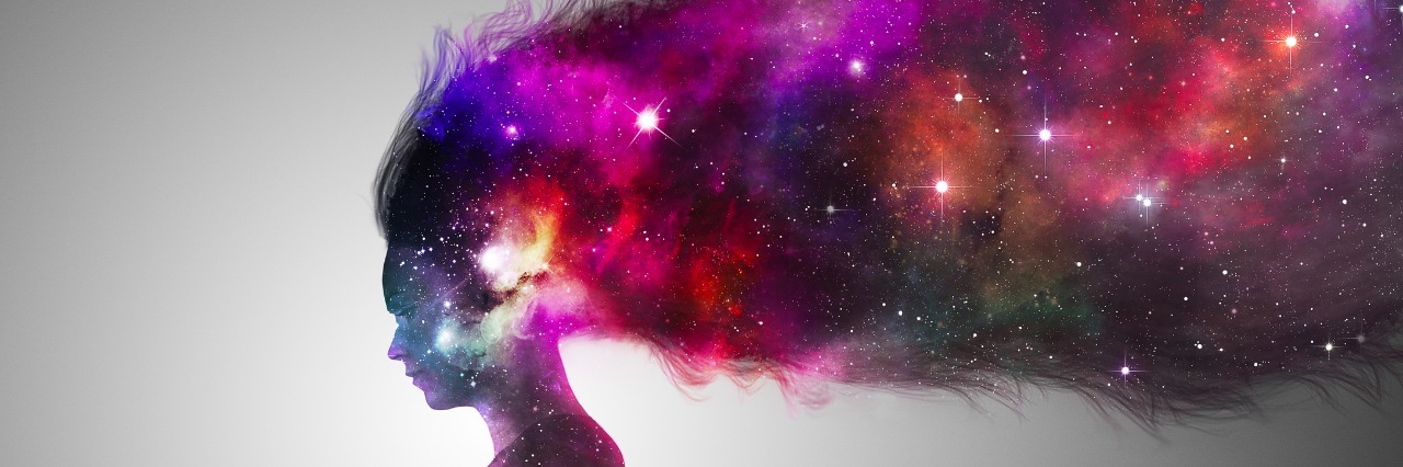 What the Hypomanic Phase Feels Like for Me A woman in silhoutte reading a book with the universe.