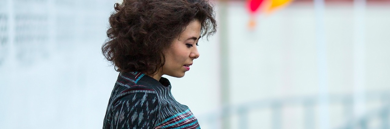 Chronic Pain and Experiencing 'Pain-Shaming' From Others Young woman on the embankment of the river in Bangkok.